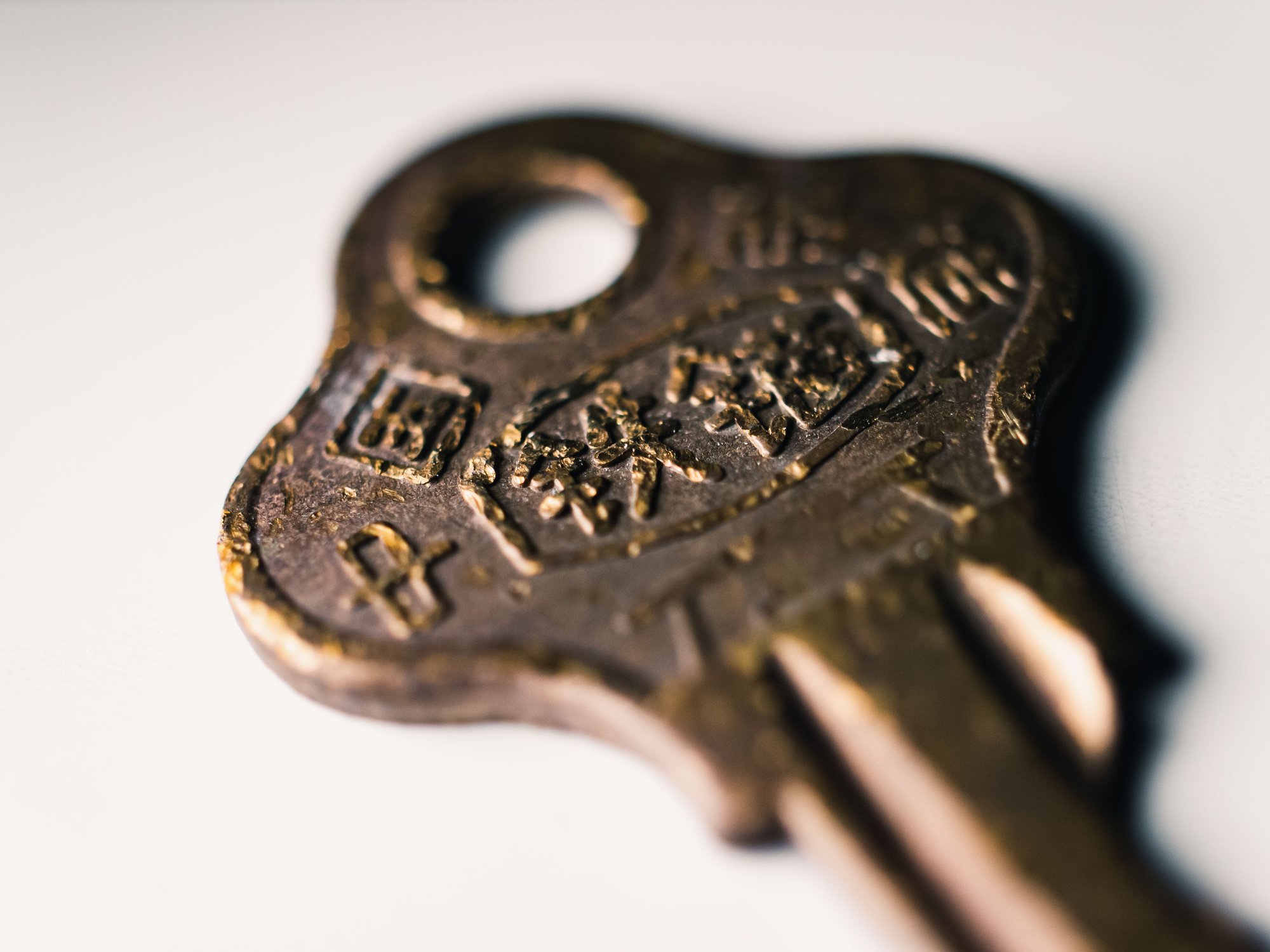 A worn brass key, close enough to see the tooling marks.