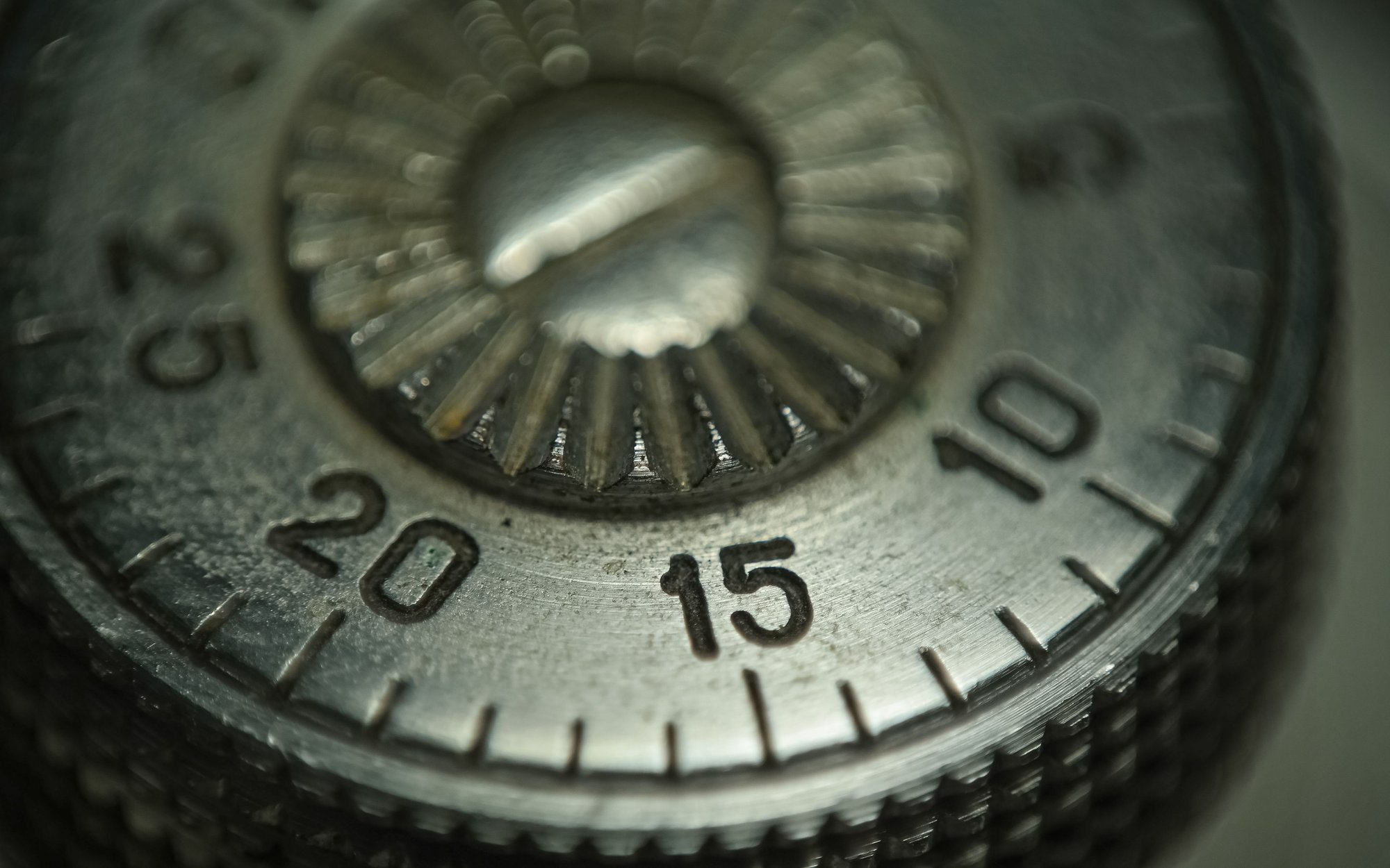 The numbered combination dial of a safe, close enough to read the notches.