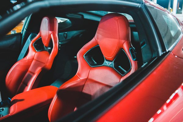 The red leather interior of a sports car, cleaned and dressed