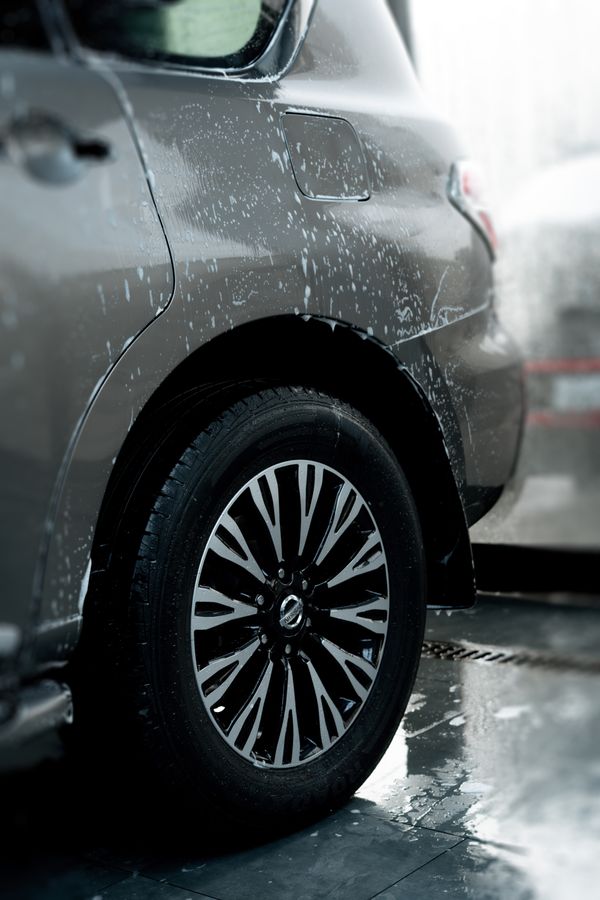 A clean alloy wheel and tire on a freshly washed SUV